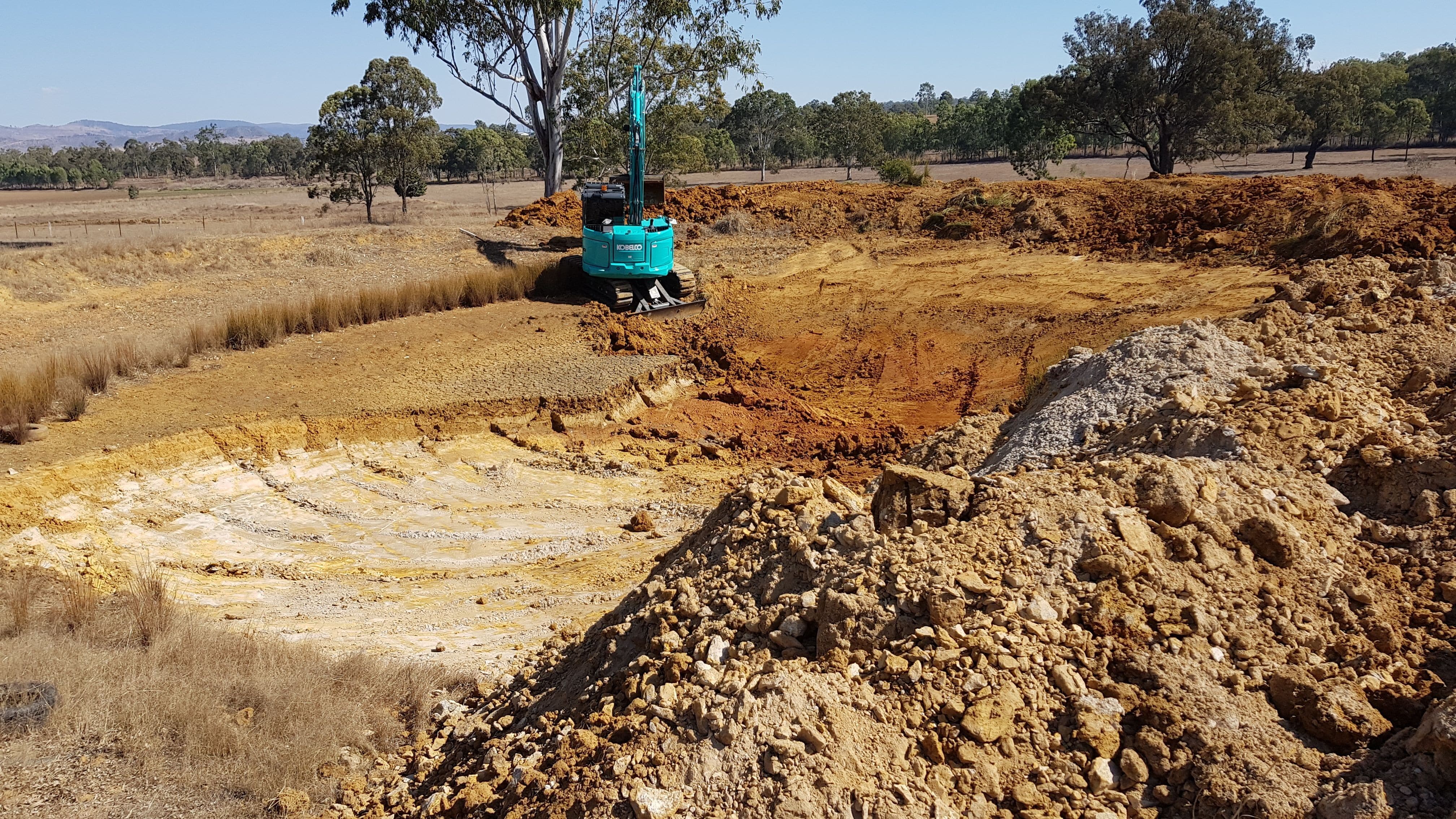 Excavating a dam for livestock watering.